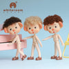 Three mini piggy BJD dolls with curly hair and movable joints posed near a pink piano.