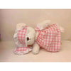 Little Bear Plush Doll in pink checkered dress, lying down, showcasing its changeable clothing feature. Soft toy for kids and collectors.