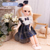 Articulated 1/6 BJD doll in plaid dress sitting with flowers and decor, showcasing realistic design and complete outfit set.