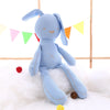 Blue kawaii bunny plush rabbit doll on a fluffy white surface with colorful flags in the background, perfect for toddlers and babies.