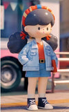 Molinta Retro Girls figure in blue jacket and shorts, featuring vintage design and a colorful headband, part of a blind box toy series.