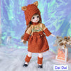 Fashion doll in bear-themed outfit with stylish dress, hat, and shoes, displayed on a furry surface with floral decor.