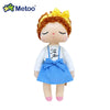 Metoo Angela Doll with curly hair, wearing a blue dress and yellow bow, showcasing adorable design and premium plush fabric.