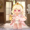 Adorable anime-inspired blind box toy figure with blonde hair, a crown, and a pink dress, holding a lantern in a magical setting.