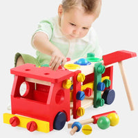 Child playing with Montessori wooden truck toy, featuring knock ball and screw nuts to develop motor skills and creativity.