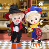 Two whimsical mini piggy BJD dolls in colorful outfits on a patterned surface, with one wearing a magician hat and the other in a clown costume.