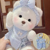 Cute little bear plush doll with changeable blue and white gingham clothes, perfect for cuddling and playtime fun.