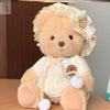 Cute little bear plush doll with lace bonnet and cozy outfit, perfect for cuddling and playtime, inspiring creativity in children.