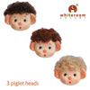 Three piglet doll heads with curly hairstyles in brown, brunette, and blonde by Whiteroom Dream.