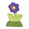 Wooden flower piece from the Kids Wooden Scene Building Toy Set, featuring a purple flower with green leaves on a grass base.