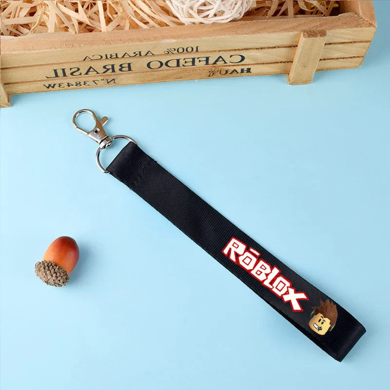 Colorful Roblox-themed keychain lanyard with creative cartoon prints, perfect for keys or bags, shown on a light blue background.