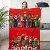 Woman holding red Roblox-themed winter sofa blanket with vibrant character design in living room.