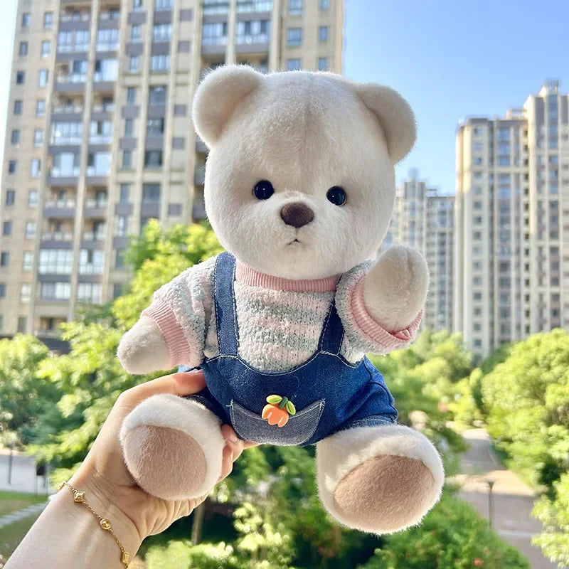 Little Bear Plush Doll with changeable clothes held outdoors, ideal for cuddling and playtime.