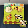 Montessori wooden puzzle for toddlers featuring farm animal shapes with knobs, designed to enhance learning and fine motor skills.