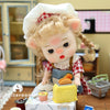 Mini piggy BJD doll in a cozy kitchen setting with a playful expression, wearing handmade clothes and interacting with a toy toaster.