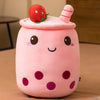 Fruit-themed milk tea cup plush pillow with a cute face and strawberry top, perfect for home decor and cozy comfort.