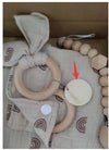 Baby teething toy set with wooden rings and gauze blanket for soothing and sensory development.