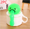 Green vomiting toy on mug for stress relief and pranks.