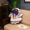 Plush astronaut pillow with unicorn design on a sofa, ideal space-themed decor for kids.