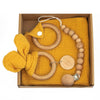 Baby teething toy gift set with beech wood rings and beads, gauze blanket in yellow, soothing and sensory development kit.