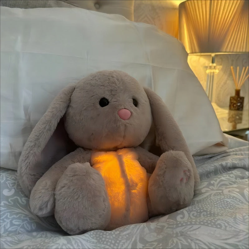 Breathing Rabbit plush toy with glowing light, designed for soothing sensory comfort in a cozy bedroom setting.