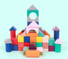 Colorful wooden building blocks arranged in creative structure on a light blue background, enhancing early development skills.