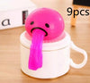 Pink squishy toy with long tongue, perfect for stress relief and pranks, displayed on a cup with "9pcs" text.