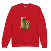 Red youth crewneck sweatshirt with Minecraft Creeper design; perfect for young gamers seeking warmth and style.